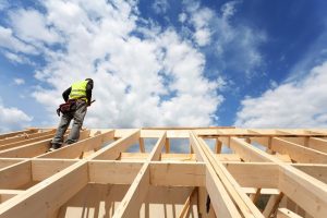 A roofing contractor examining a new home